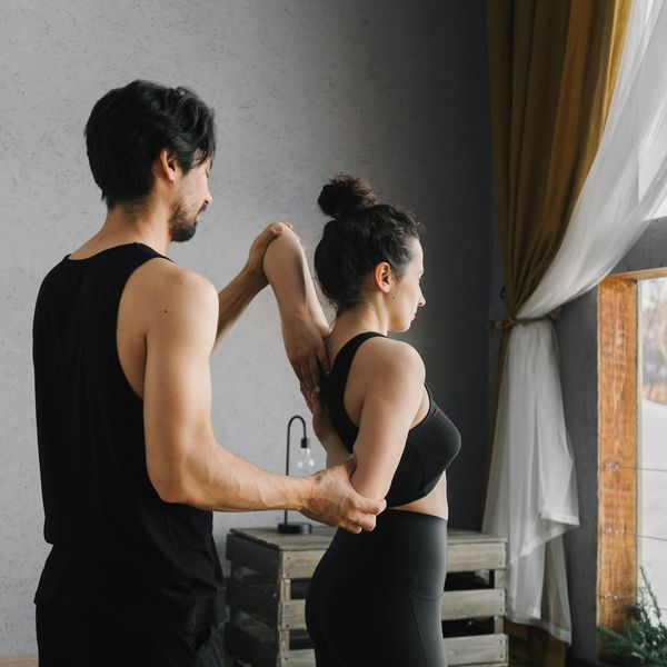 Smiling woman stretching outdoors, feeling full of vitality and positive energy.